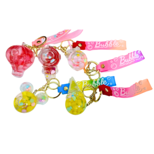 A collection of colorful bubble water keychains with cute designs, including a hot air balloon, astronaut, gumball machine, Mickey, and ice cream cone.