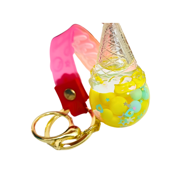 A yellow ice cream cone-shaped keychain with liquid and floating beads.