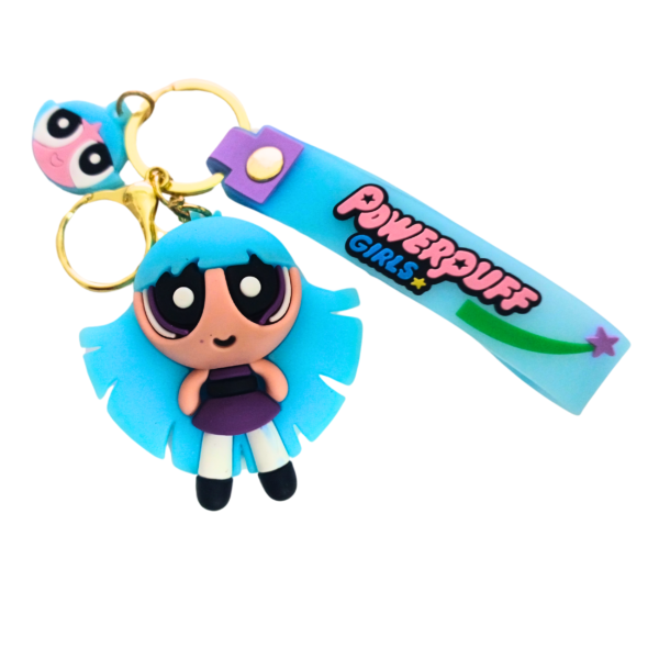 A blue Powerpuff Girls keychain featuring Bubbles with her signature pigtails, attached to a blue "Powerpuff Girls" silicone strap and a gold keyring.