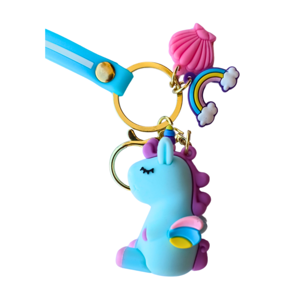 Blue unicorn keychain with a sky-blue strap, rainbow charm, and pink shell pendant.